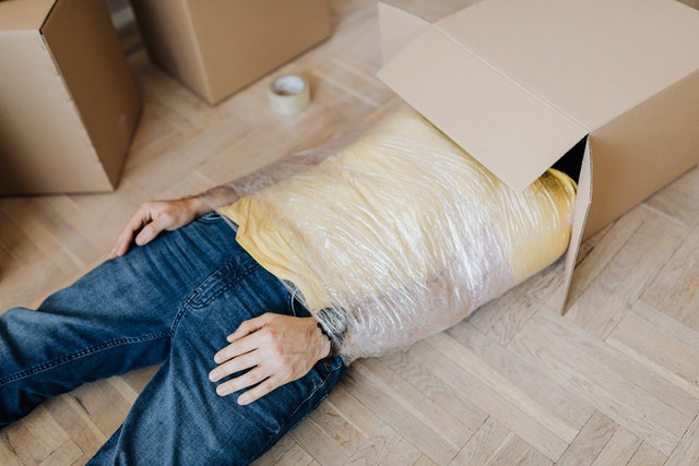 man-tied-up-using-tape-with-head-in-carton-box