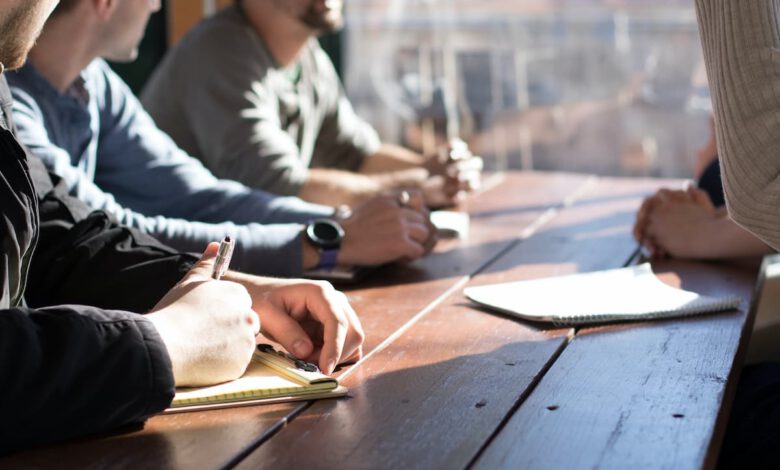 people sitting on chair in front of table